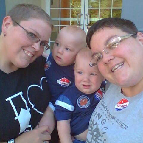 Andrea and Becky with their twin boys after voting in 2013.